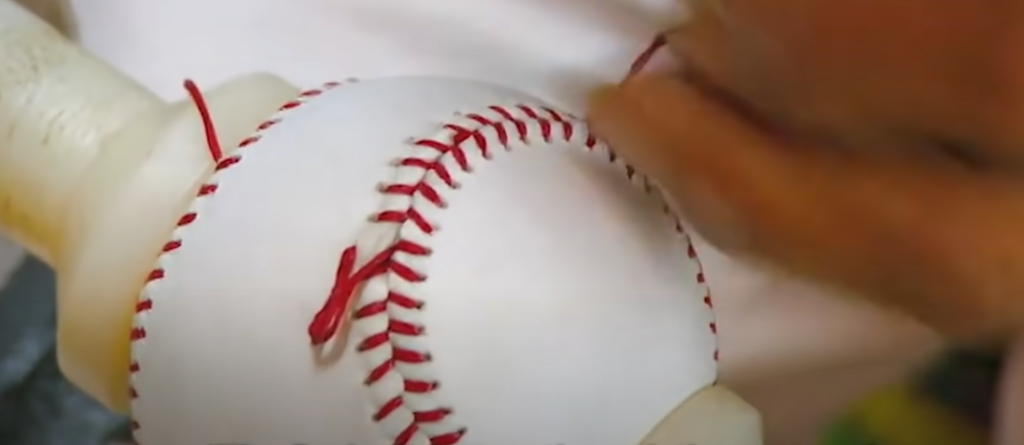 Are baseballs still stitches by hand?